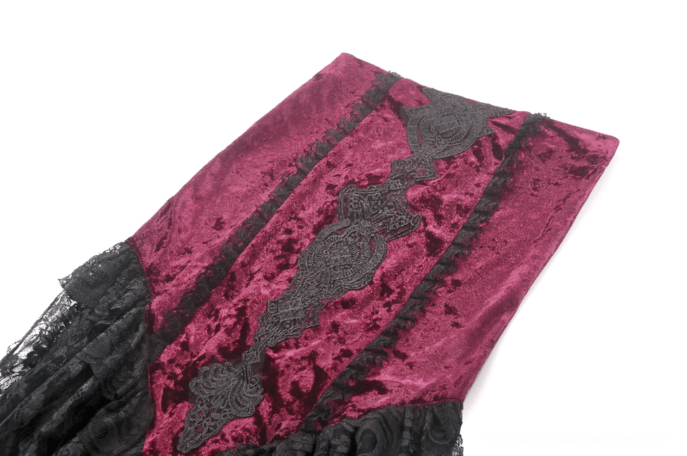 Side close-up of burgundy velvet bodice meeting black lace ruffled edge on high-low gothic skirt
