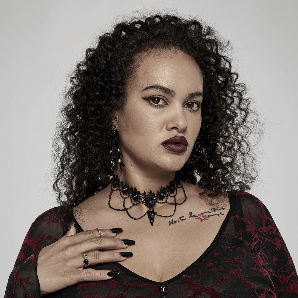 Gothic lace choker worn by curly-haired goth model with dark vamp makeup and moody aesthetic
