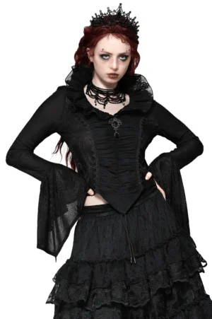 Black Victorian gothic blouse front view featuring dramatic ruffled collar, ruched bodice, flared bell sleeves with lace trim, and ornamental filigree brooch on red-haired model