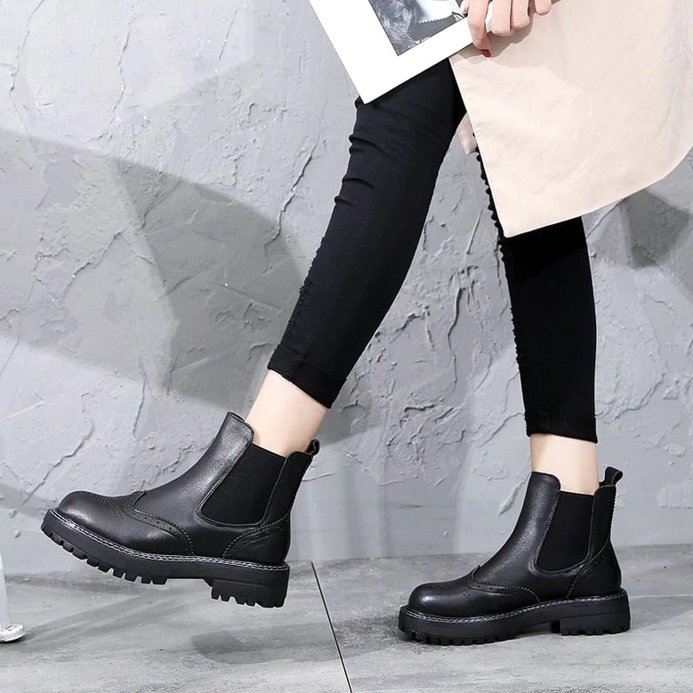 Victoria-inspired dark Chelsea boots showing structural construction and leather craftsmanship