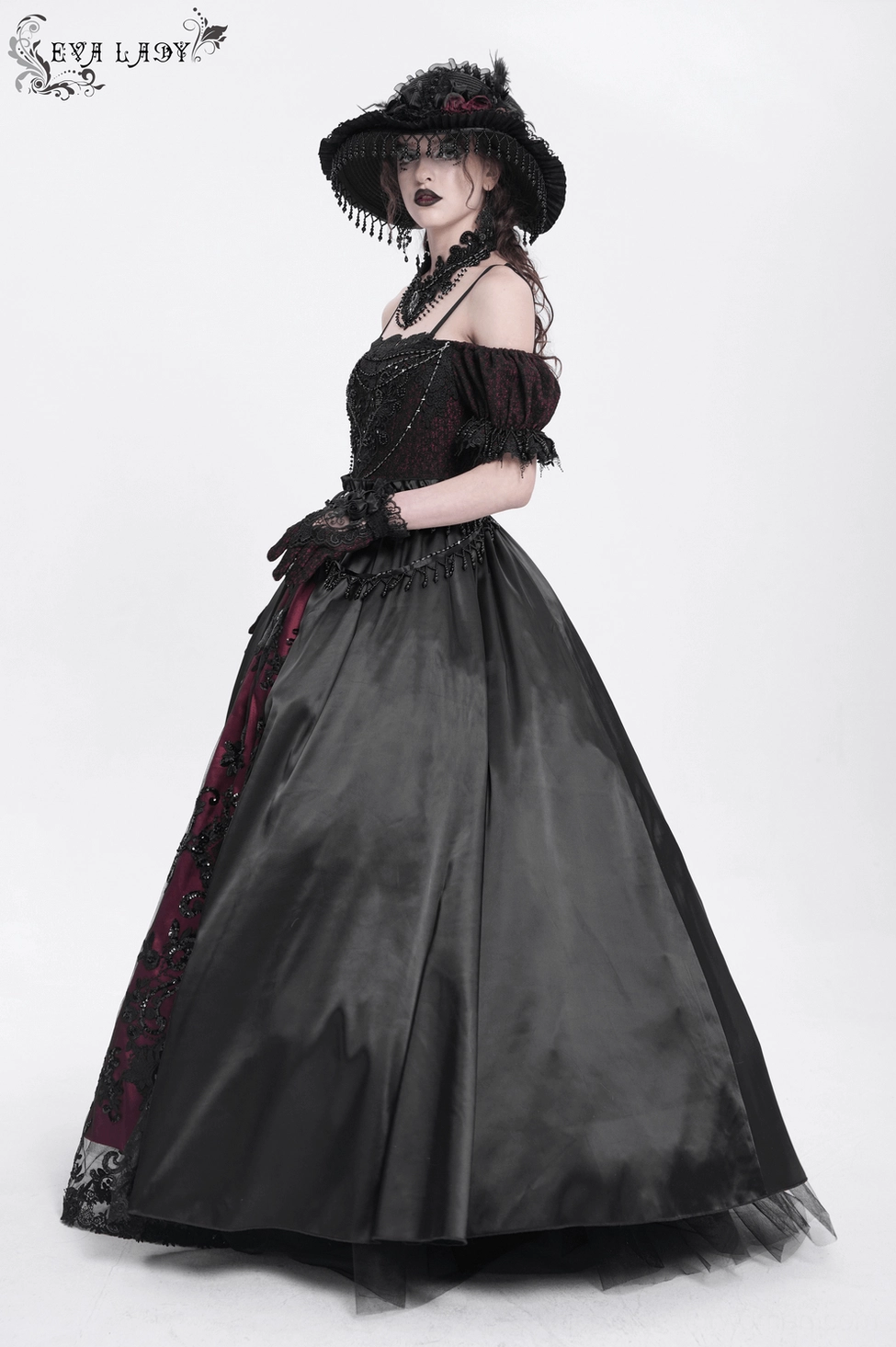 Close-up texture detail of Victorian gothic gown fabric showing ruffle construction, lace-up straps, and layered design elements