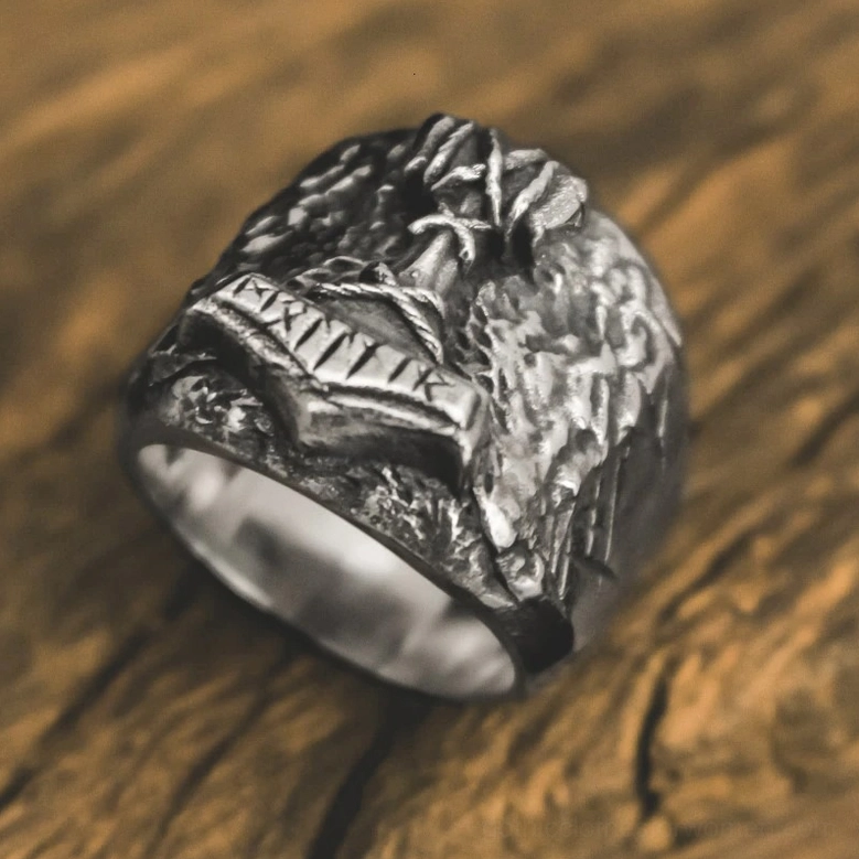 Viking signet ring top-down oblique view showing polished inner band with rune engravings and rugged exterior texture