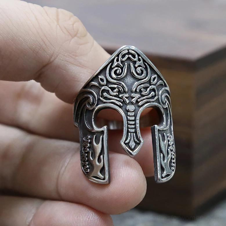 Viking helmet gothic ring held in hand front close-up carved design clear view