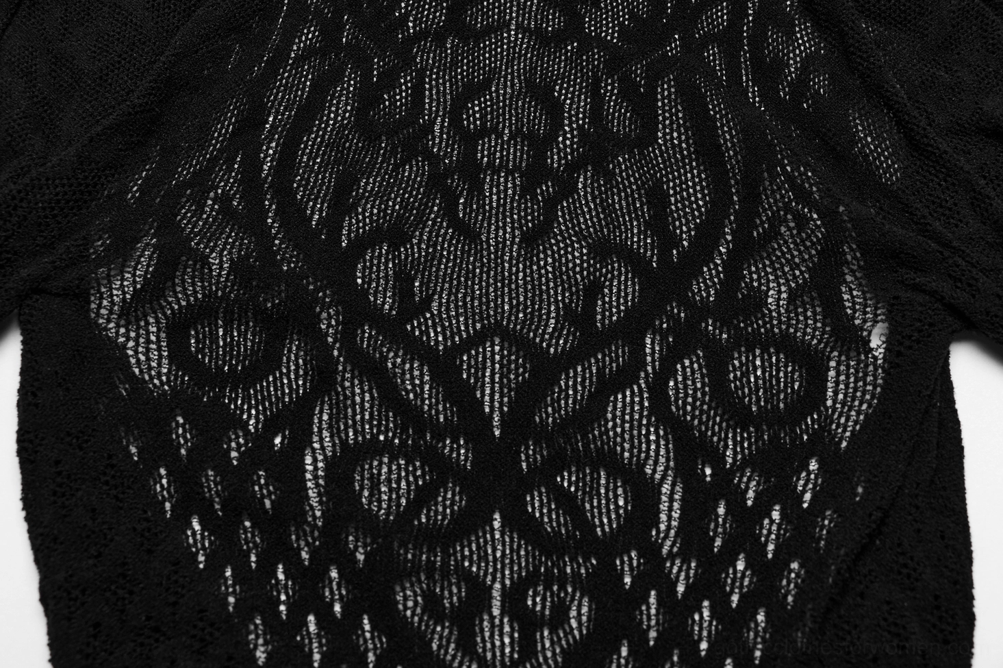 Close-up detail of intricate vine lace pattern on black mesh fabric with floral gothic motif
