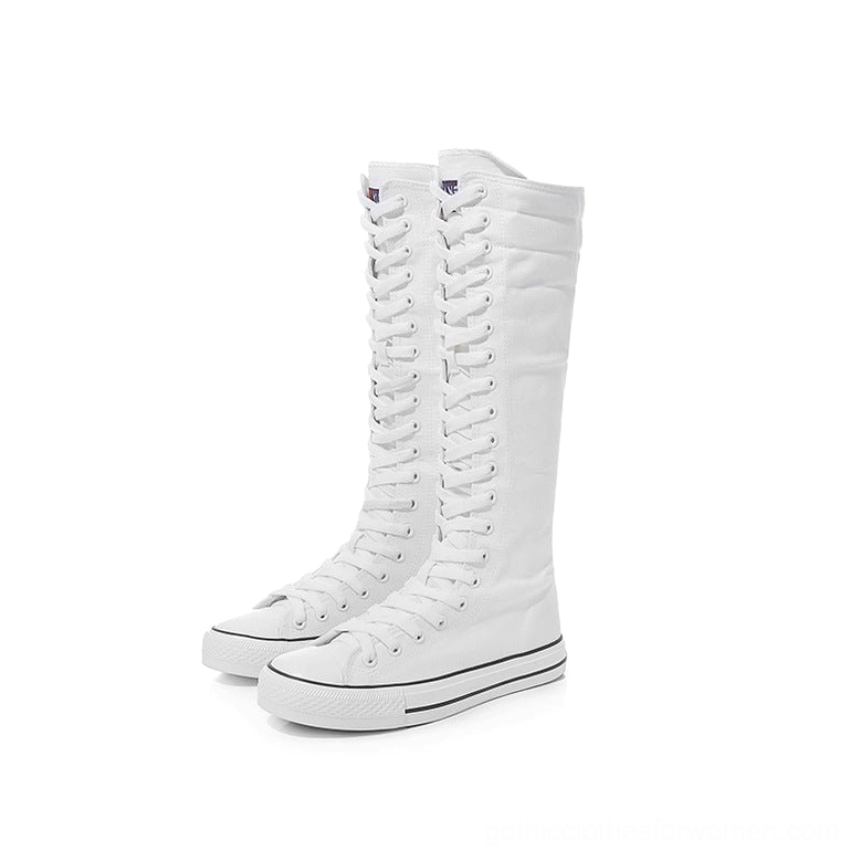 White knee-high canvas boots lace-up design with black toe cap and outsole trim