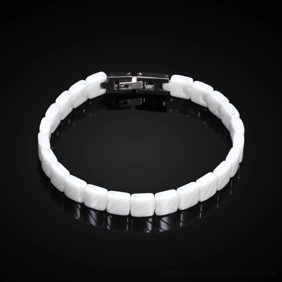 White ceramic bracelet on reflective black glossy background showcasing matte finish