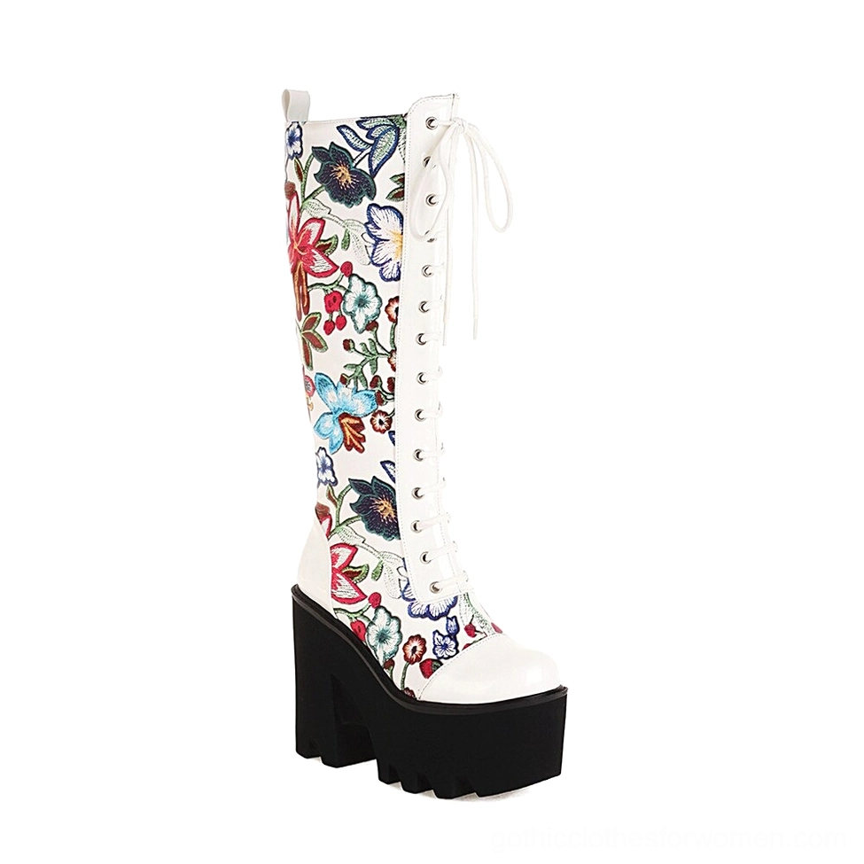 White gothic floral platform knee-high boots with lace-up closure and black TPU chunky sole, studio front view