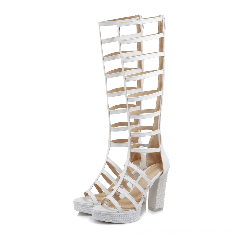 White knee-high gladiator block heel sandal front view with open toe platform sole and geometric straps