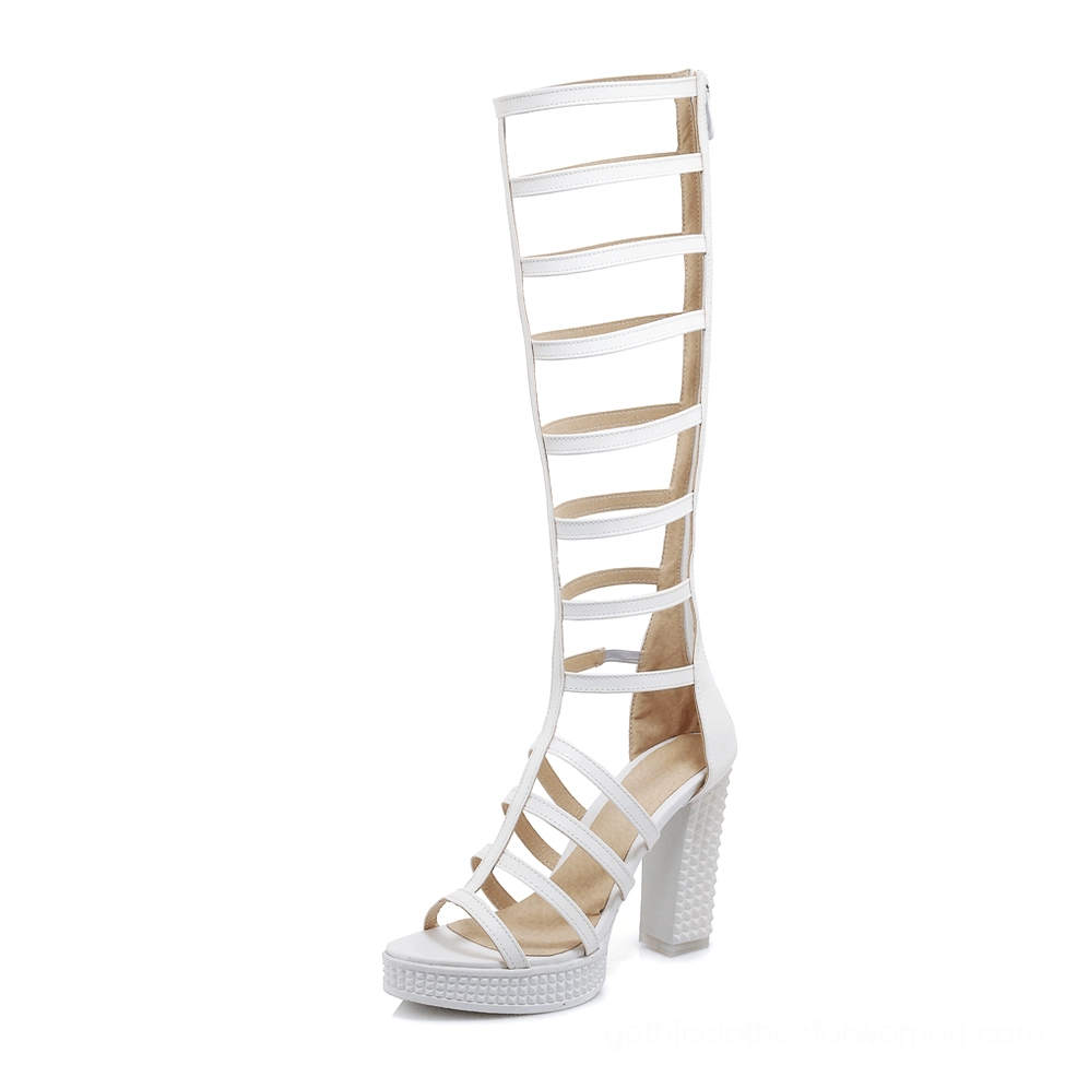White knee-high gladiator heel sandal inner side view showing platform sole and geometric cutout straps