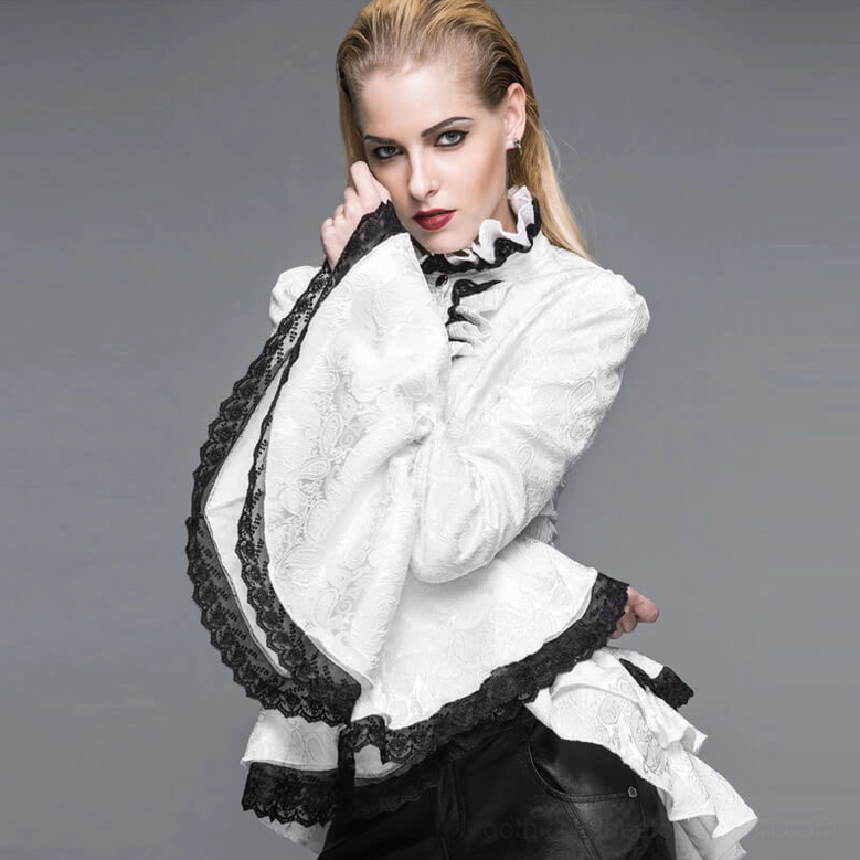 Three-quarter back view of model in white gothic blouse showing ruffled back hem, black lace sleeve trims, and gothic styling