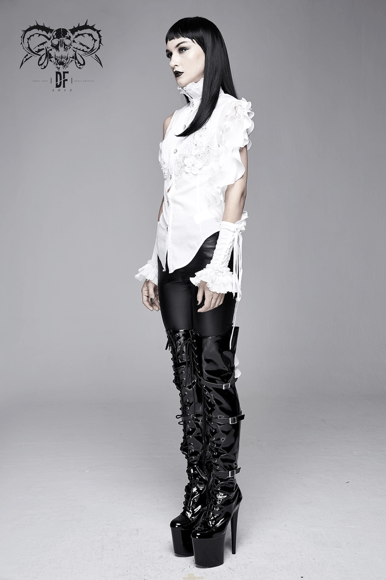 White gothic blouse displayed on mannequin with full frontal view highlighting embroidery work and architectural silhouette