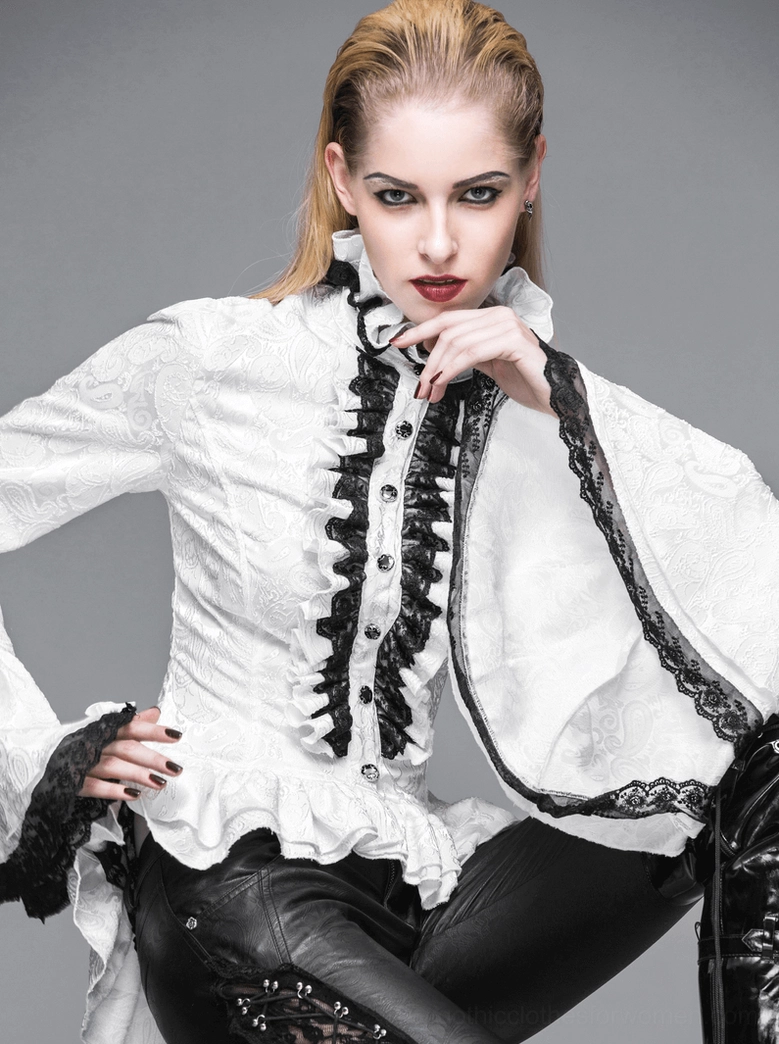 Model wearing white gothic blouse with extra black lace on sleeve edges paired with leather pants and boots, three-quarter view