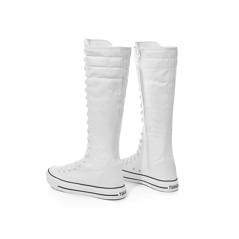Pair of white canvas high-top boots side profile with zipper and branded rubber sole