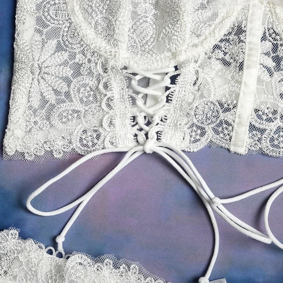 White gothic lace lingerie bra showing three-quarter cup design and adjustable features