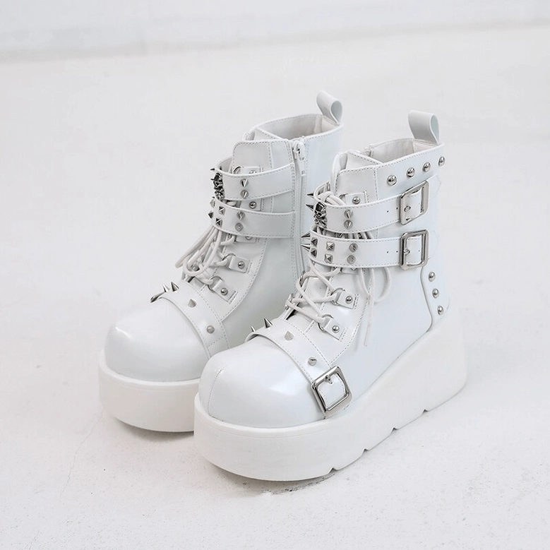 White gothic platform ankle boots pair front view with lace-up and spike details