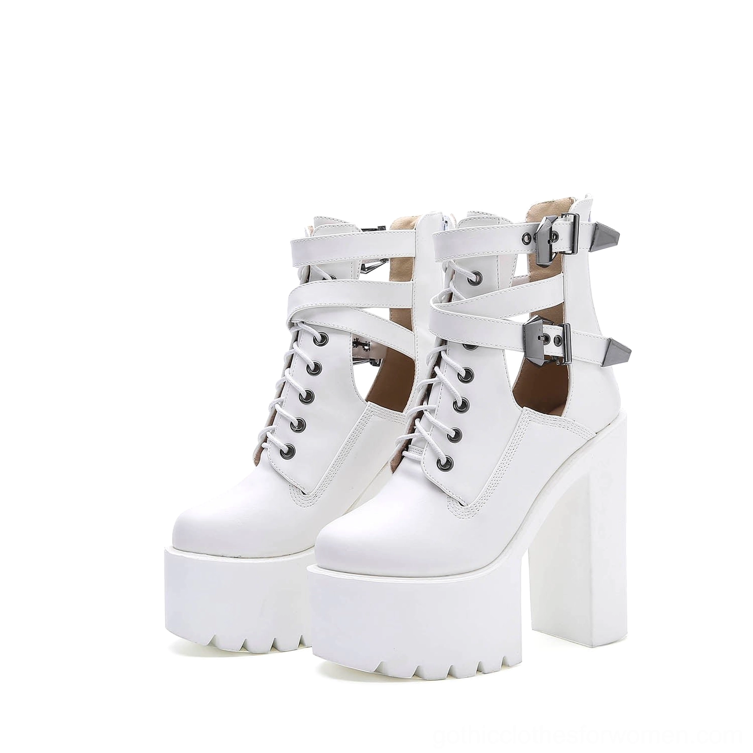White platform lace-up ankle boots with decorative buckle straps and architectural cutout details, front three-quarter angle showcasing the substantial platform sole