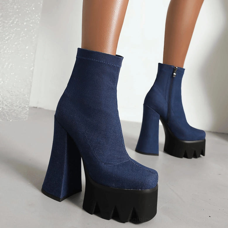White genuine leather gothic platform boots heel view emphasizing square block heel and ankle support