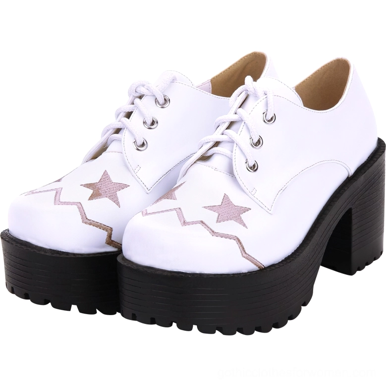 Pair of white lace-up platform oxford shoes front three-quarter view with embroidered star motifs and black lugged platform