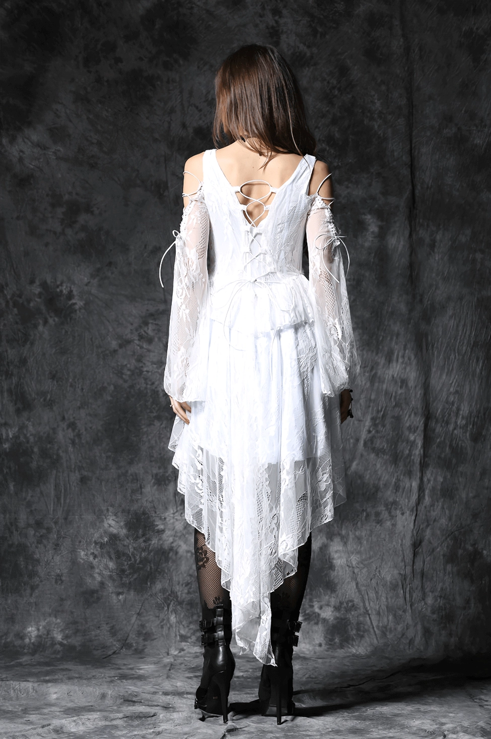 White gothic lace dress back view with intricate lace-up corset ties and long sheer sleeves