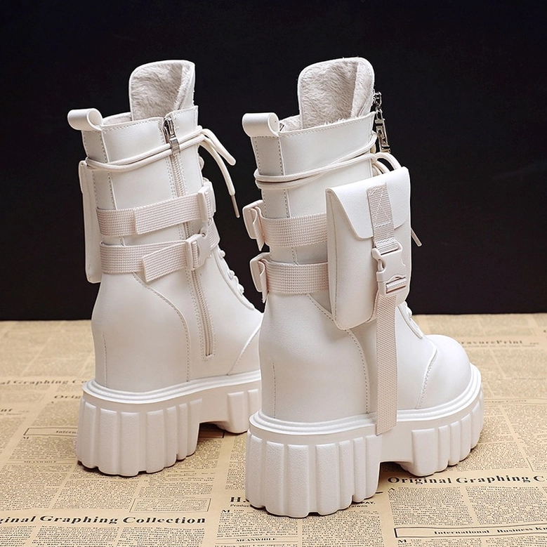 White PU leather ankle platform boots with furry lining, side pocket detail, and lug sole on newspaper background