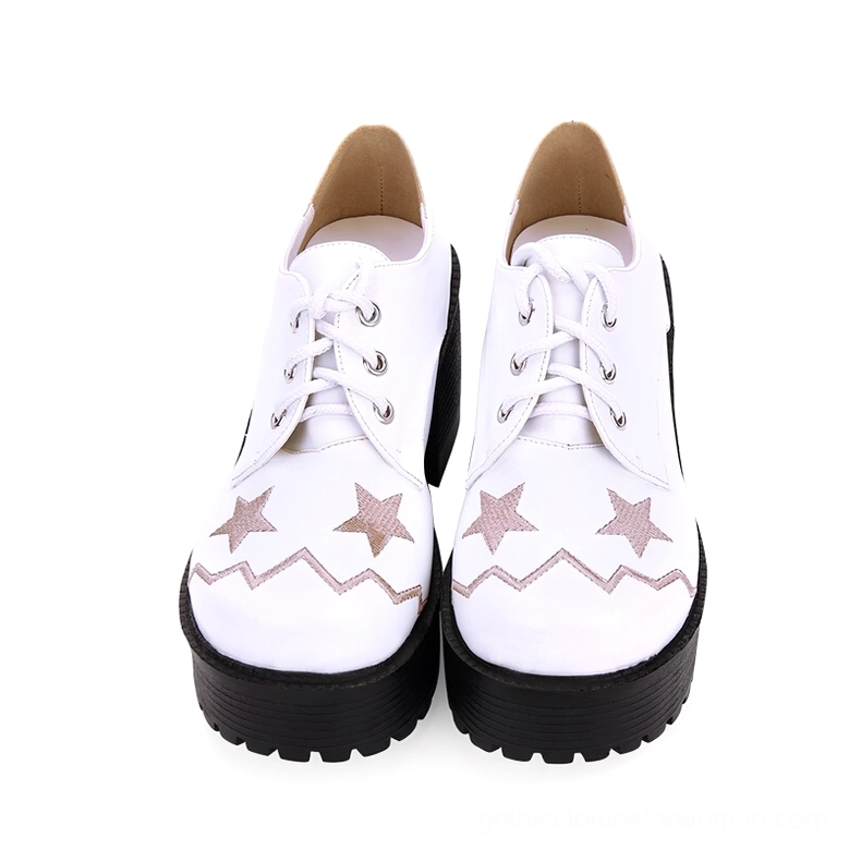 White platform lace-up oxfords top front view showing smooth leather upper and embroidered star and zigzag design