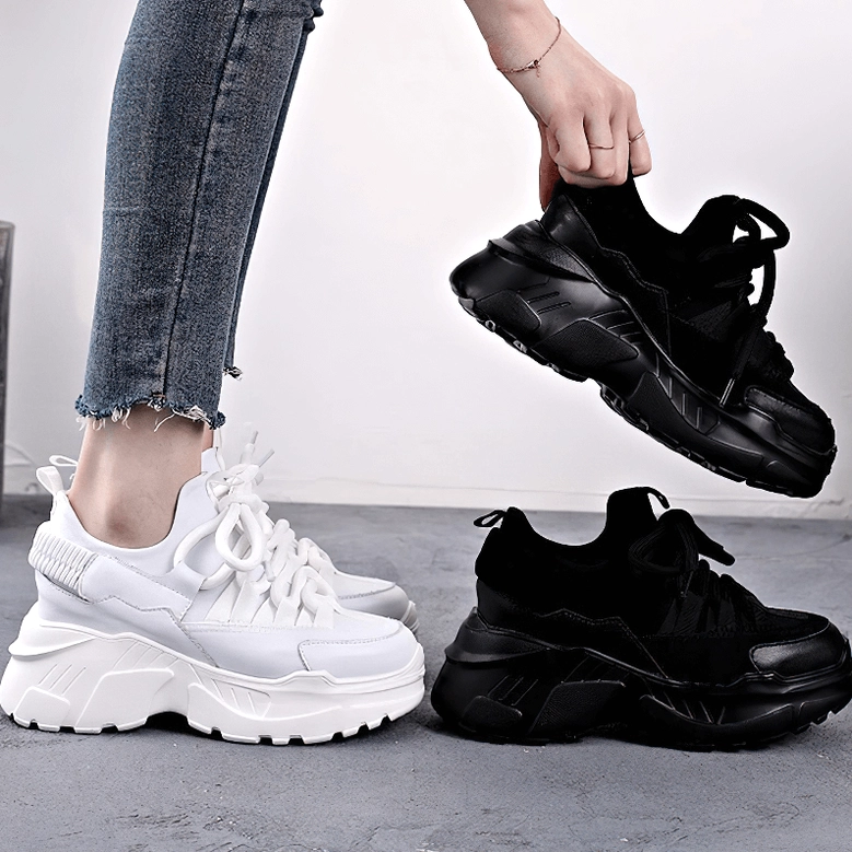 White platform leather sneaker side profile emphasizing thick sole and elevated heel structure