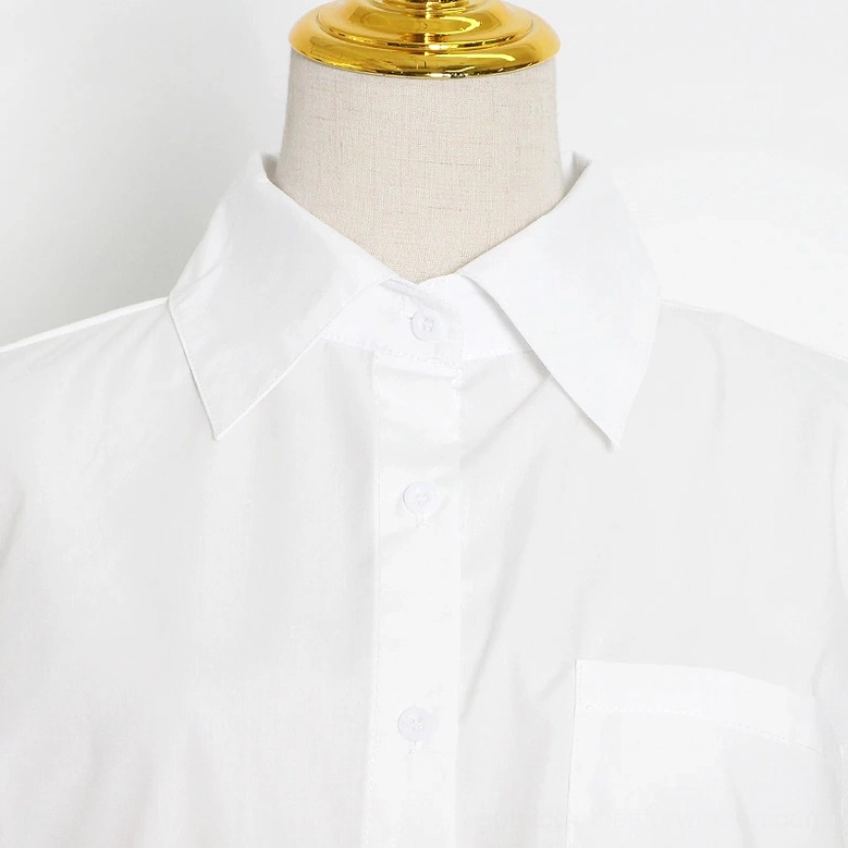 White puff sleeve shirt close-up showing structured collar and smooth cotton fabric texture detail
