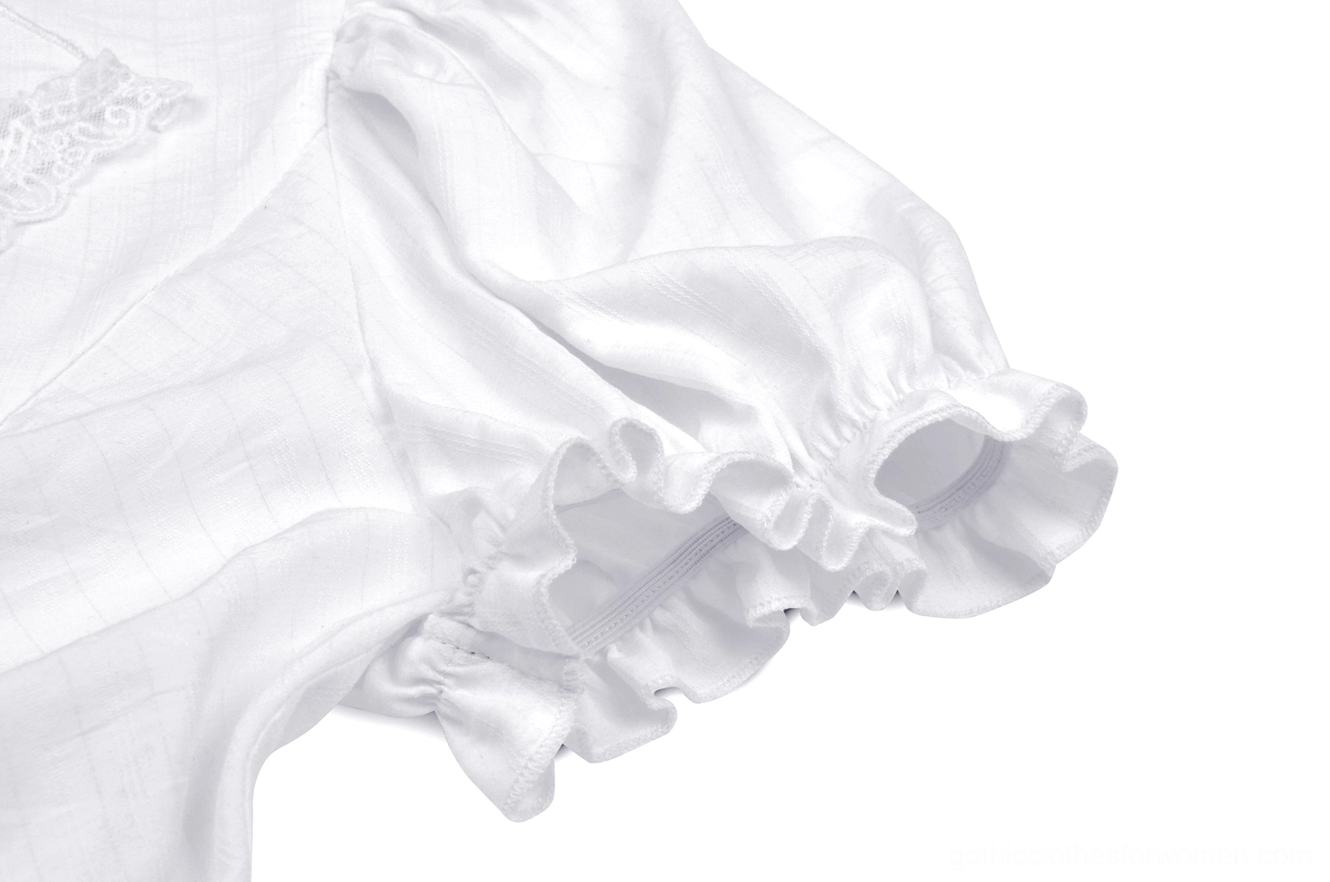 White puff sleeve cuff with delicate lace ruffle trim on ivory Victorian-inspired gothic blouse