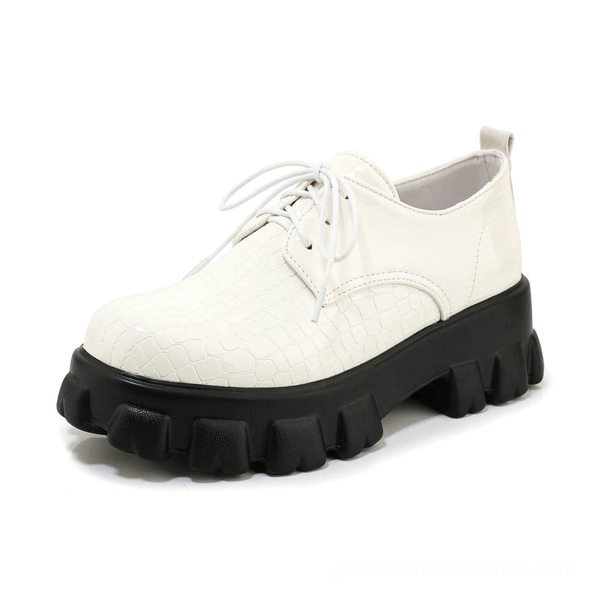 White snake-texture lace-up platform pump front view emphasizing round toe, lace closure, and reptilian pattern detail