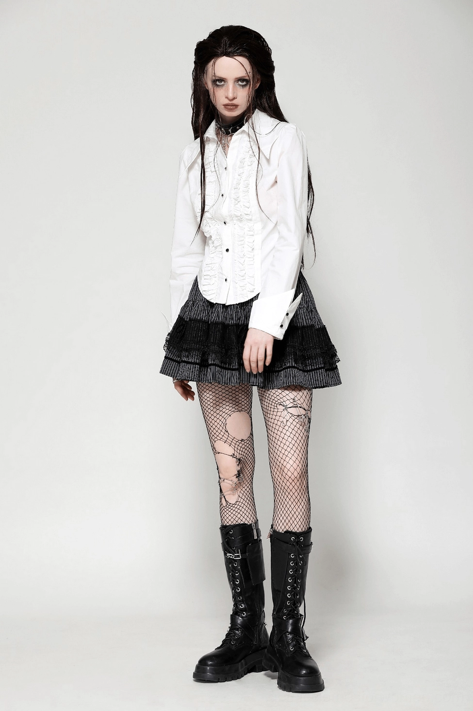 White ruffled gothic blouse featuring Victorian-inspired design with black button details and long sleeves
