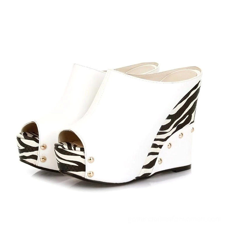 White zebra print wedge sandals with metallic rivet accents and peep-toe slide style for dark aesthetic fashion