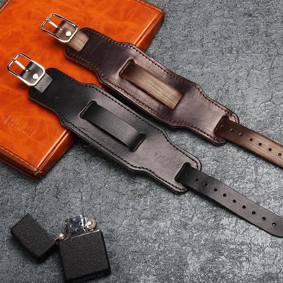 Leather gothic bracelets with notebook and lighter, professional flat lay composition showcasing buckle detail and leather notebook pairing