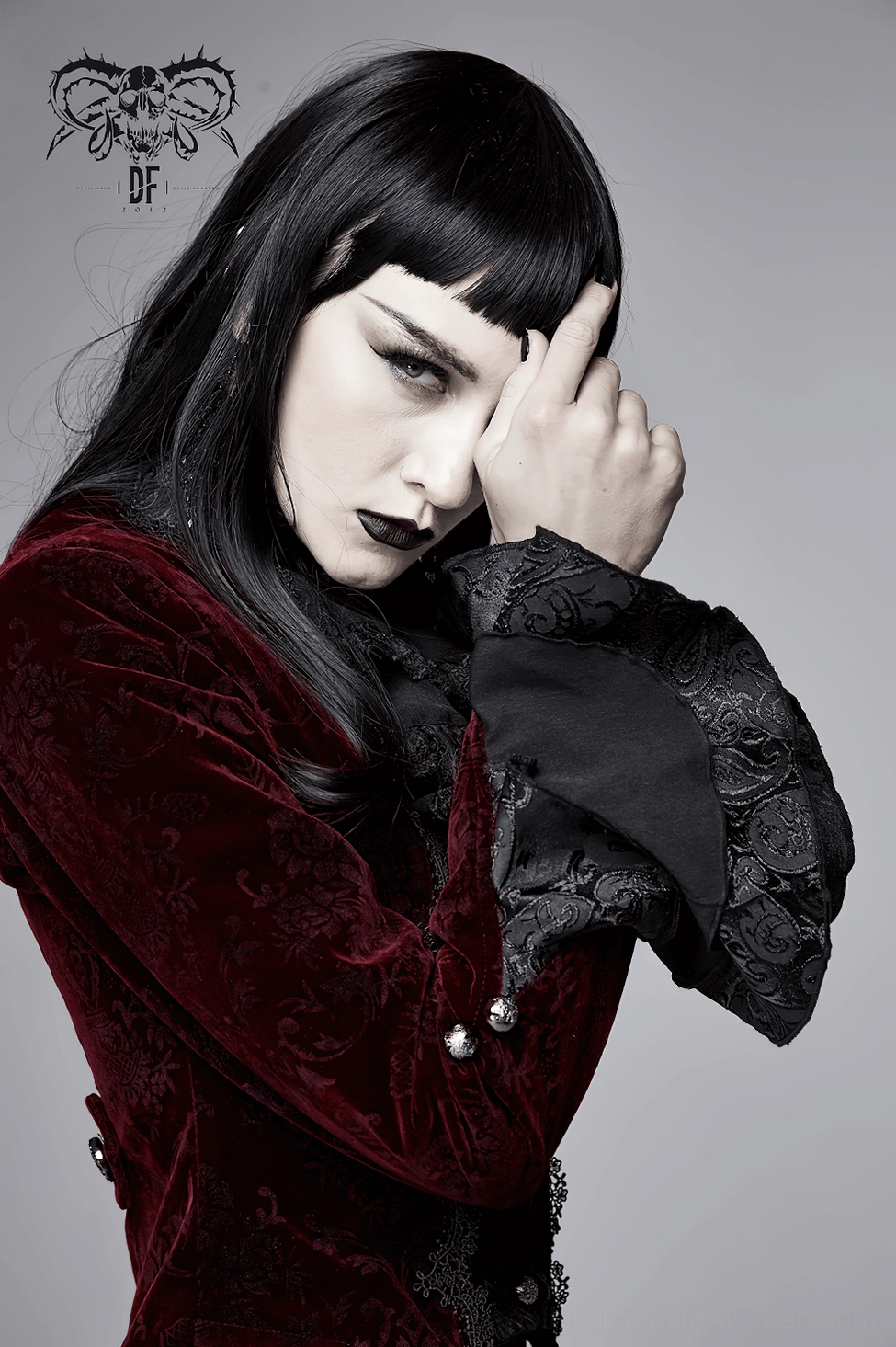Button detail and front closure design of wine red gothic velvet tailcoat jacket