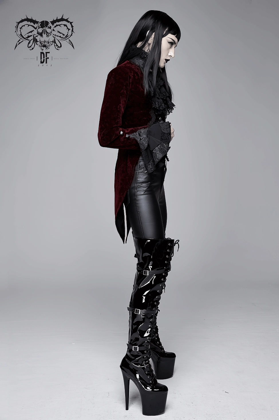 Close-up detail of ruffled lace stand collar on wine red gothic velvet tailcoat jacket