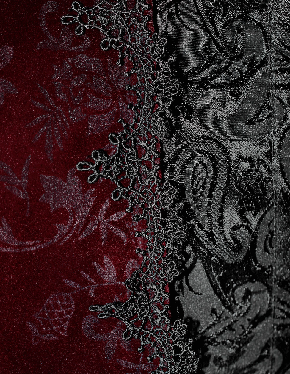 Shoulder and sleeve construction detail of wine red velvet gothic tailcoat showing slim-fitting design