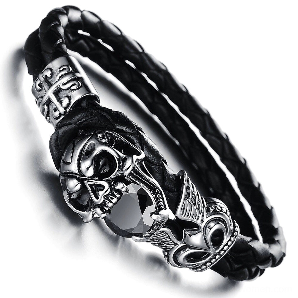 Close-up top view of winged skull charm with black cubic zirconia stones on stainless steel, gothic bracelet detail shot