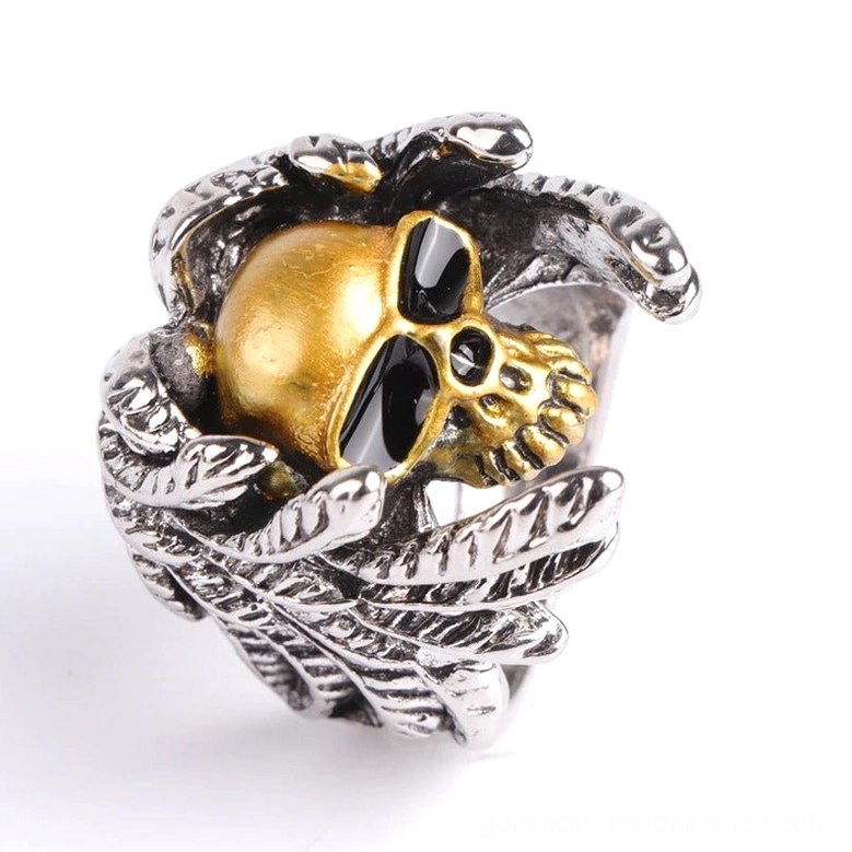 Oblique display winged skull ring top side view, silver feather details with black enamel accents