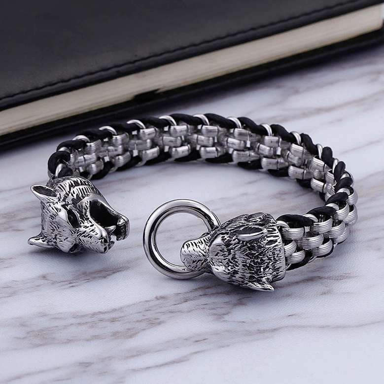 Wolf head bracelet with detachable wolf head charm on marble surface, braided chain design with multiple styling options