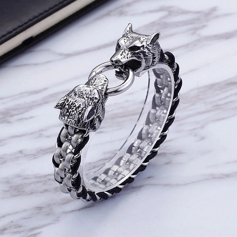Close-up side view of wolf head bracelet featuring detailed carved wolf head clasp and leather braiding