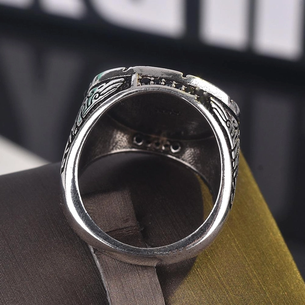 Wolf head ring back view inner band engravings vintage silver metal on dark fabric gothic accessory