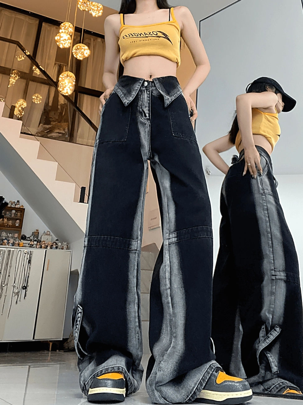 Female model wearing black high-waist denim pants with yellow crop top in luxury boutique showroom setting