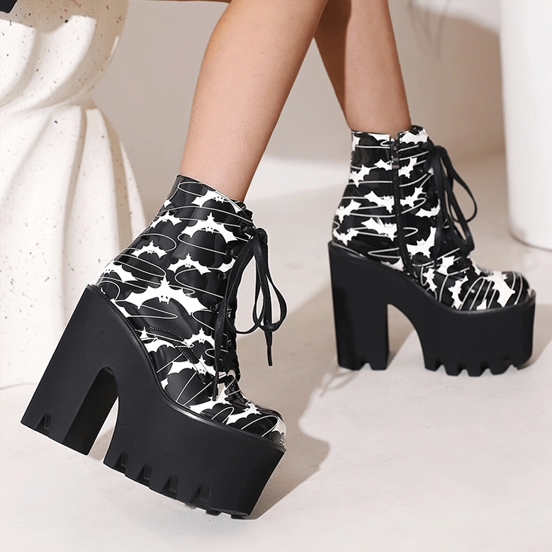 Women's gothic platform ankle boots with bat print design, full front view displaying lace-up system, dual closure mechanism, and commanding presence