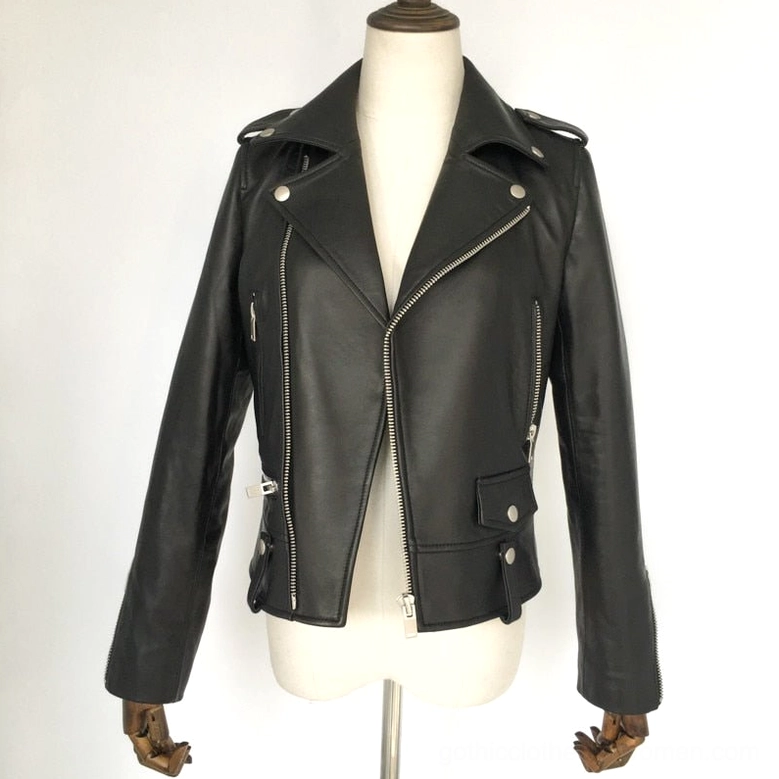 Left three-quarter front view of women's black genuine leather biker jacket with open lapel, multiple silver zippers, and tailored silhouette