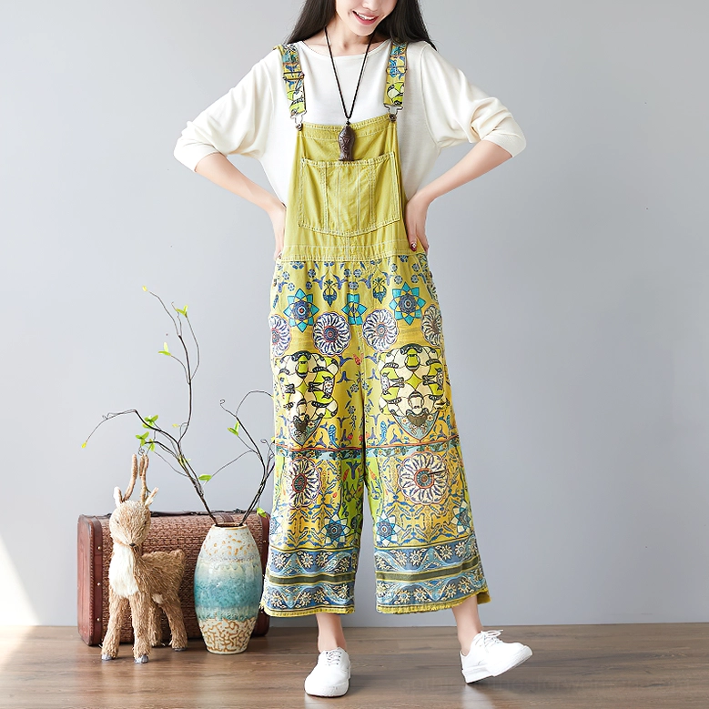 Yellow psychedelic floral wide-leg gothic pants front view hands on hips statement pose