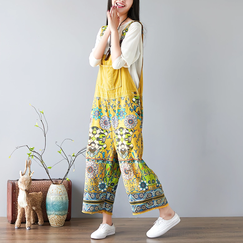 Yellow ethnic floral print wide-leg gothic pants full side profile with home decor styling