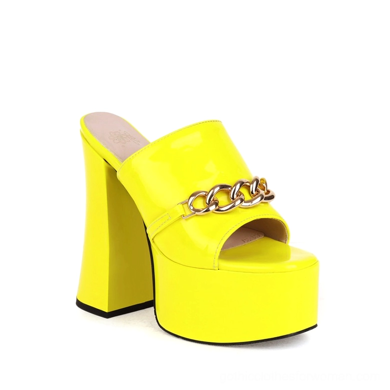 Bright yellow patent leather gothic platform mule heels with chunky gold chain detail and peep-toe opening