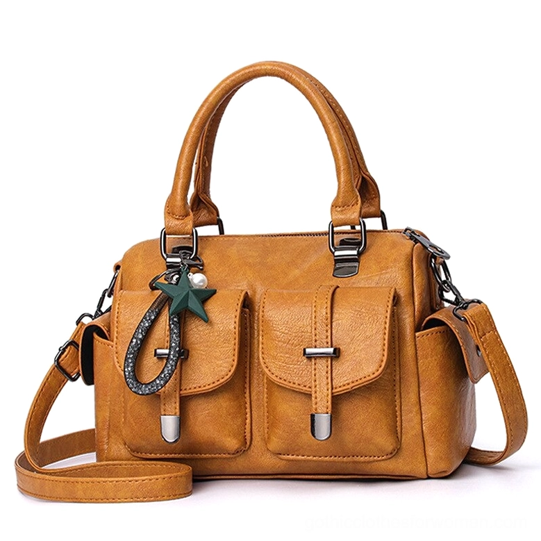 Yellow mustard leather boston handbag with gothic star charm, dual front pockets, and polyester lining