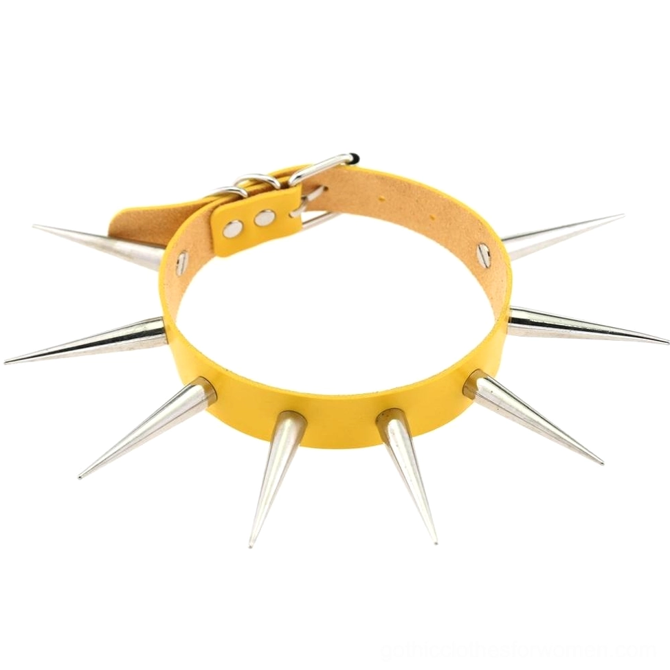 Yellow faux leather spiked choker necklace with silver metal spikes flat lay display on white background bold