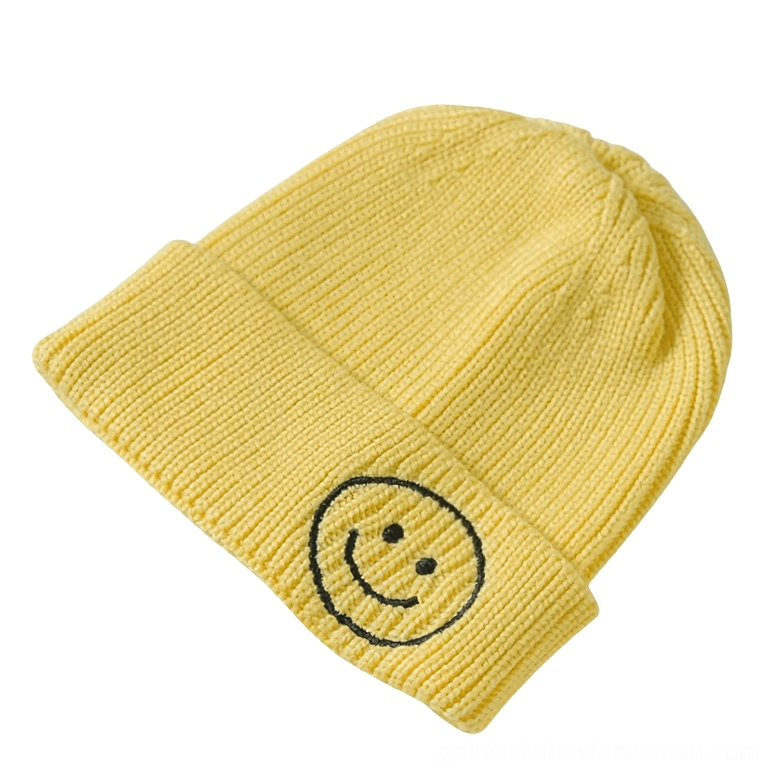 Yellow smiley face embroidered knit beanie with black smiley logo, cheerful dark aesthetic knit hat