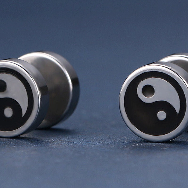 Pair of tai chi stud earrings flat lay dark blue background stainless steel enamel